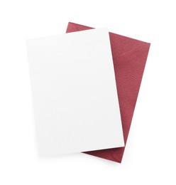 Photo of Blank invitation card and envelope isolated on white, top view. Space for design