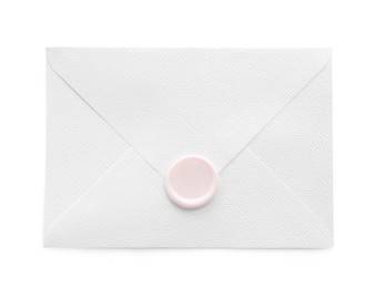Photo of Beautiful invitation envelope with wax seal isolated on white, top view