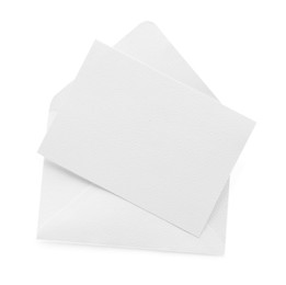 Photo of Blank invitation card and envelope isolated on white, top view. Space for design