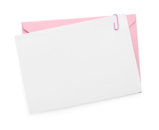 Photo of Blank invitation card and envelope isolated on white, top view. Space for design