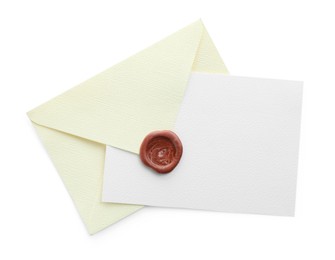 Photo of Blank invitation card and envelope isolated on white, top view. Space for design
