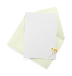 Photo of Blank invitation card and envelope isolated on white, top view. Space for design