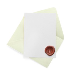 Photo of Blank invitation card and envelope isolated on white, top view. Space for design