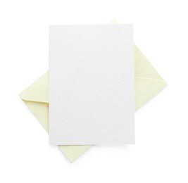 Photo of Blank invitation card and envelope isolated on white, top view. Space for design