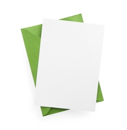 Photo of Blank invitation card and envelope isolated on white, top view. Space for design