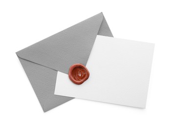 Photo of Blank invitation card and envelope isolated on white, top view. Space for design
