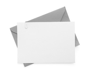 Photo of Blank invitation card and envelope isolated on white, top view. Space for design