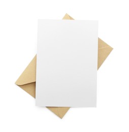 Photo of Blank invitation card and envelope isolated on white, top view. Space for design
