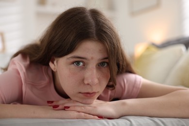 Photo of Depressed teenage girl on bed at home
