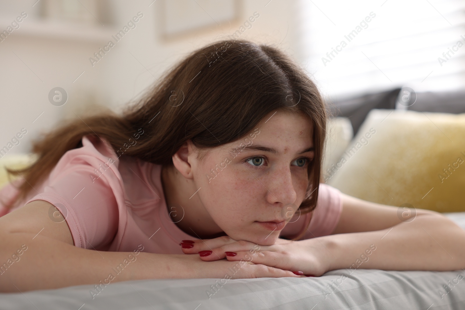 Depressed teenage girl on bed at home Photo of Depressed teenage girl on bed at home