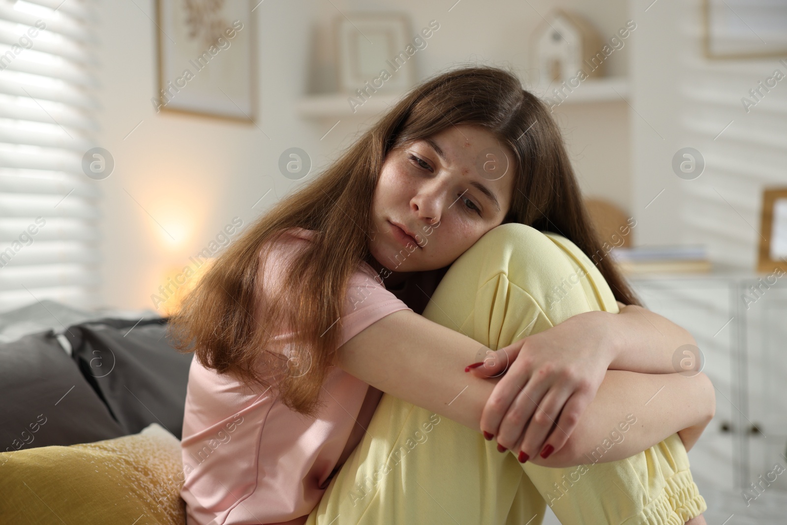 Depressed teenage girl on bed at home Photo of Depressed teenage girl on bed at home