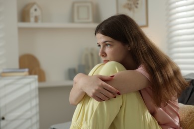 Photo of Depressed teenage girl on bed at home. Space for text