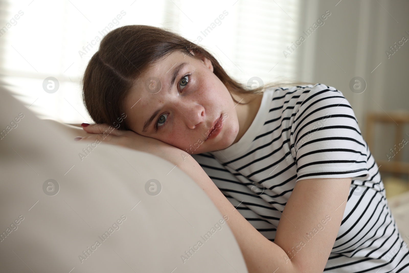 Depressed teenage girl on sofa at home Photo of Depressed teenage girl on sofa at home