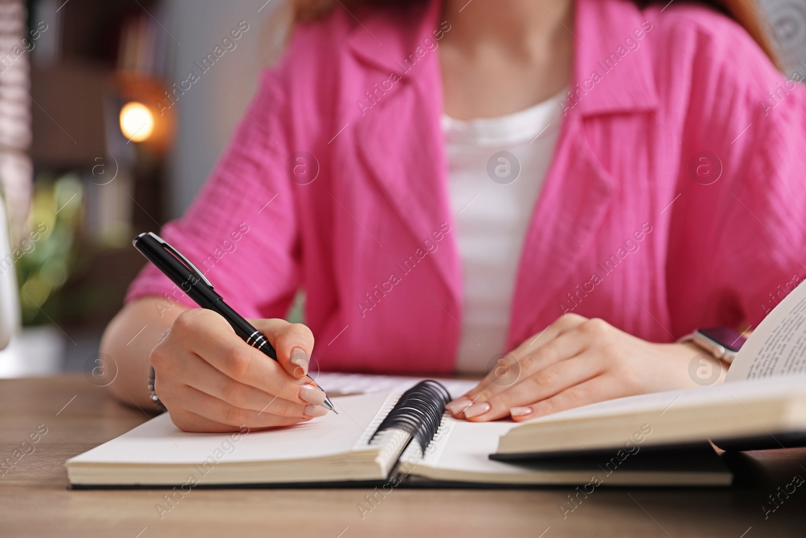 Teenage student taking notes while studying at table indoors, closeup Photo of Teenage student taking notes while studying at table indoors, closeup