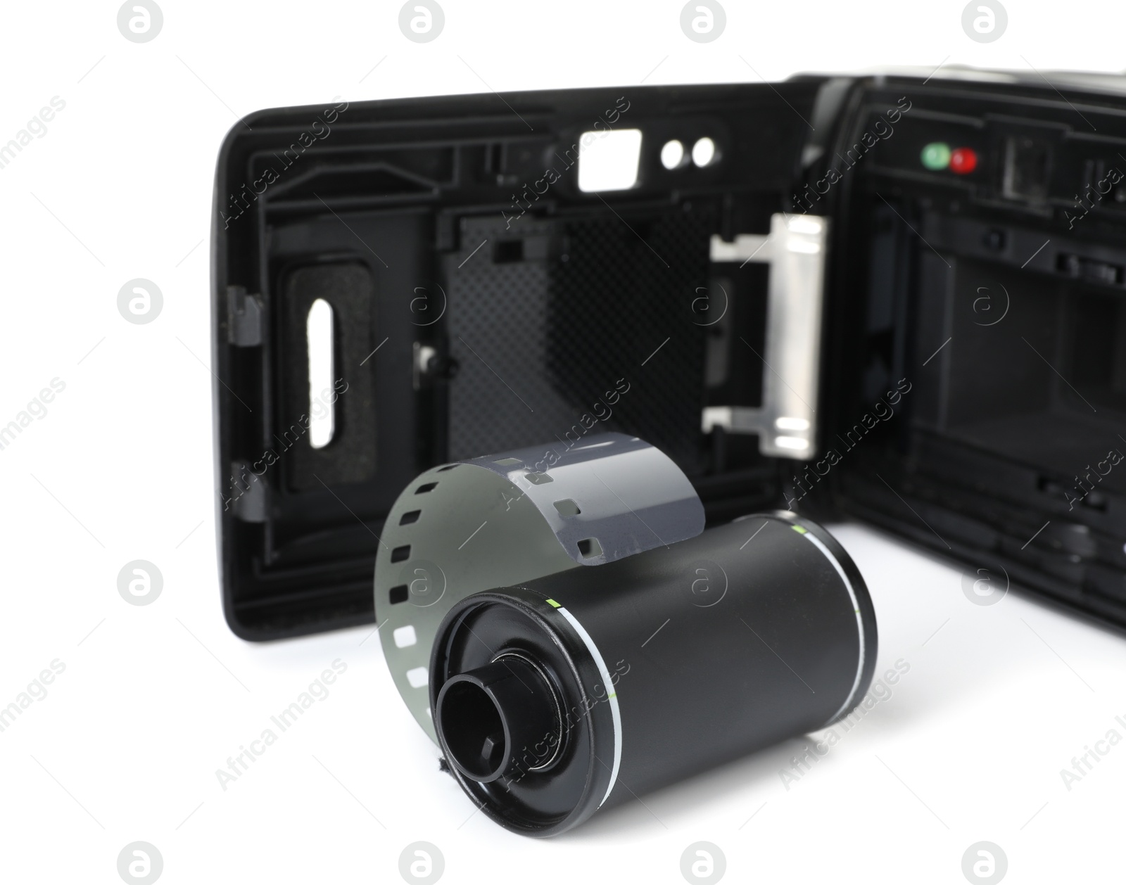 Roll of photographic film and photo camera isolated on white Photo of Roll of photographic film and photo camera isolated on white