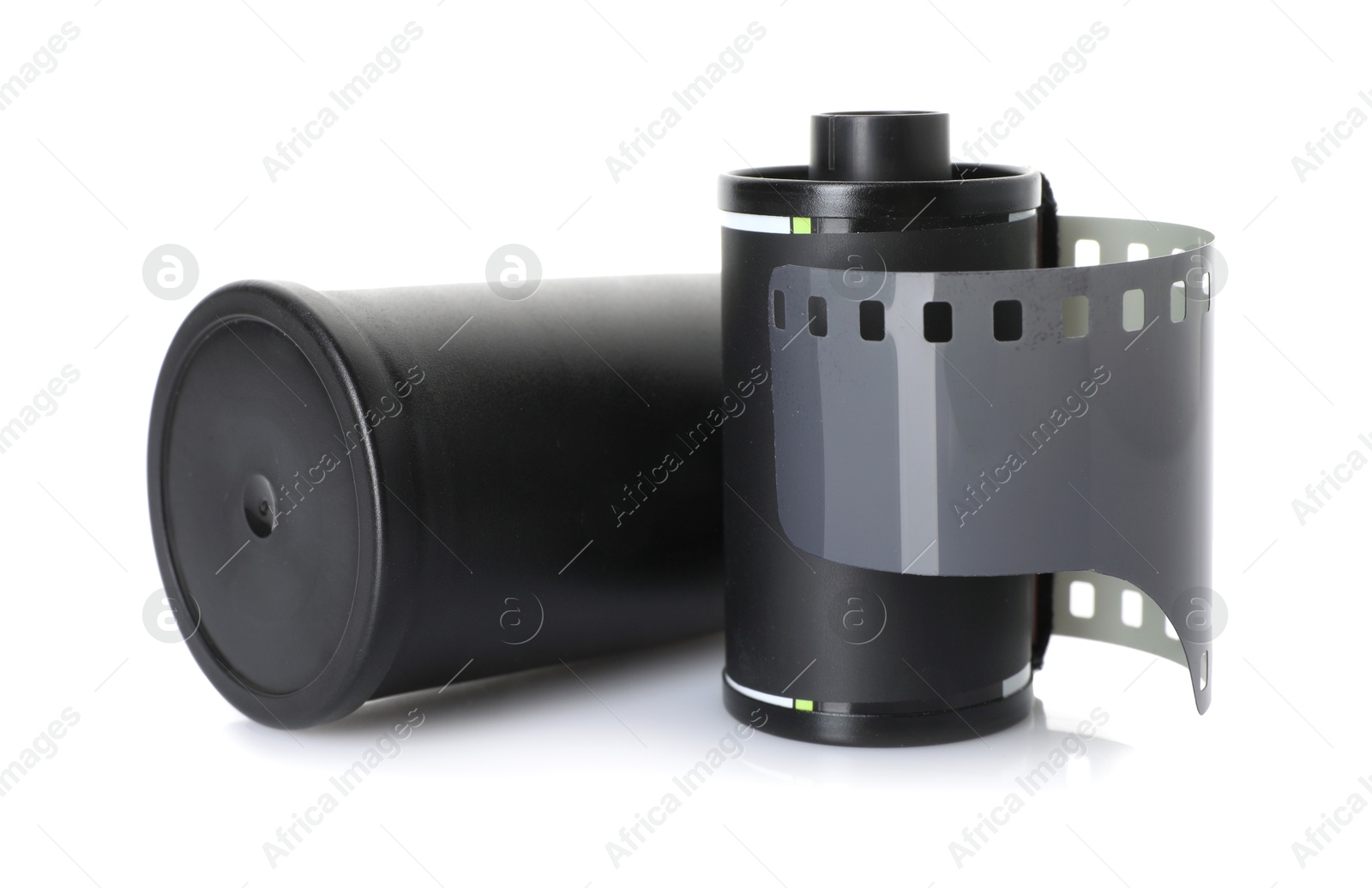 Roll of photographic film and canister isolated on white Photo of Roll of photographic film and canister isolated on white