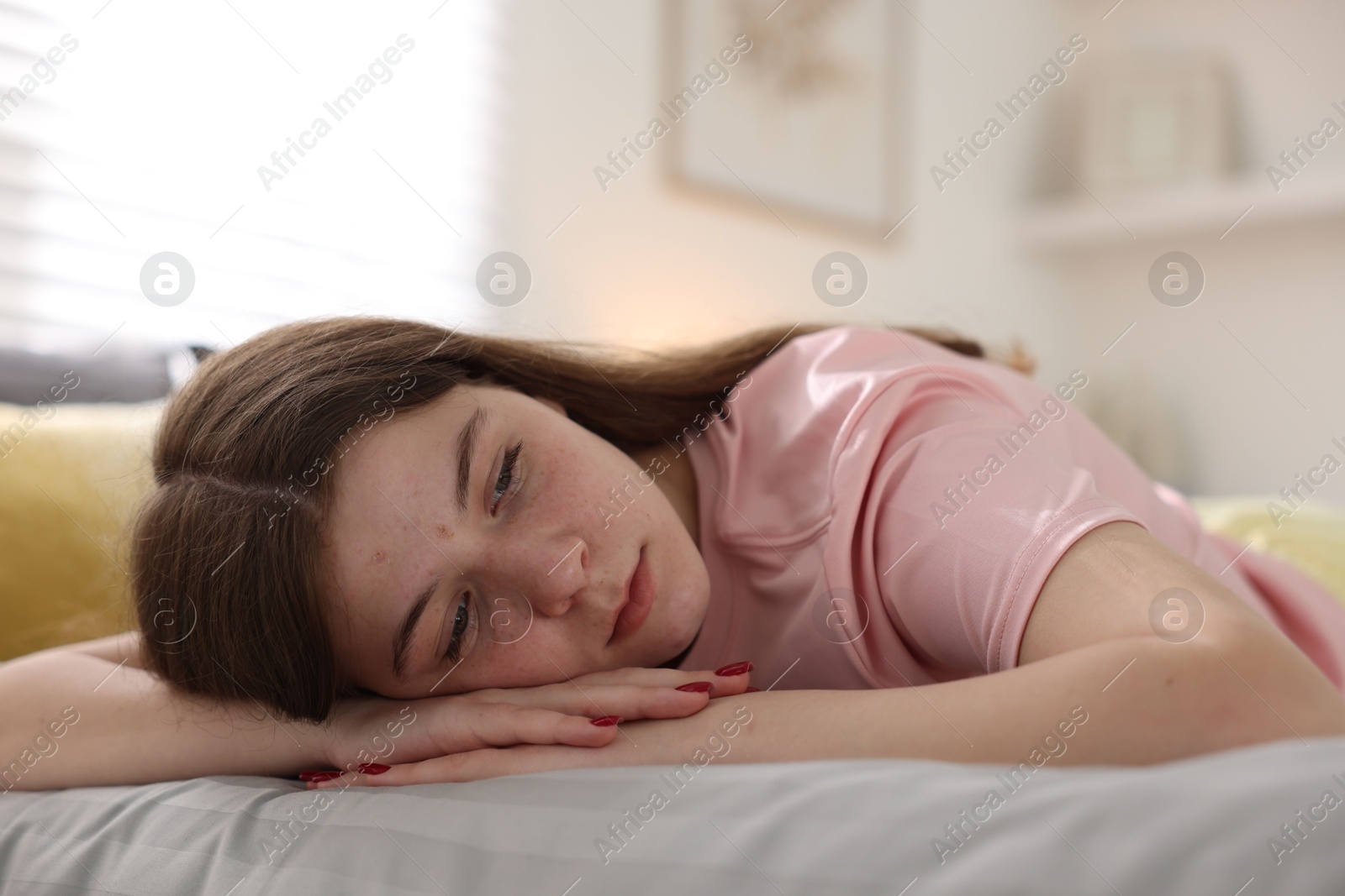Depressed teenage girl on bed at home Photo of Depressed teenage girl on bed at home