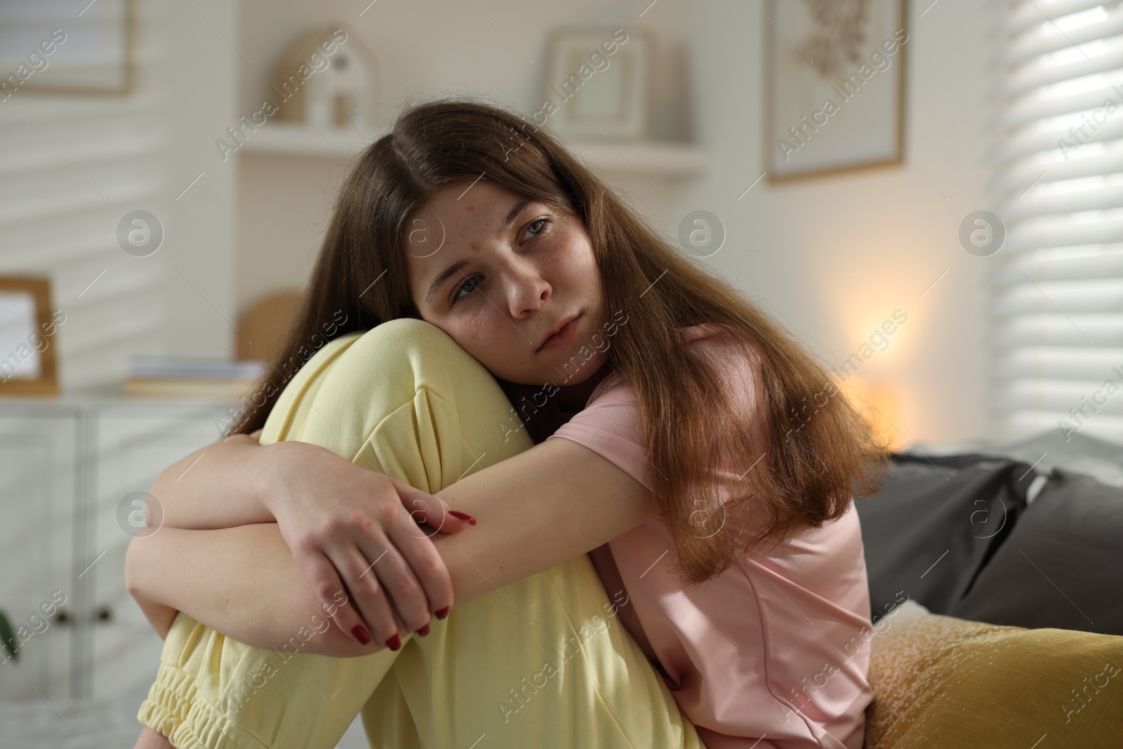 Depressed teenage girl on bed at home Photo of Depressed teenage girl on bed at home