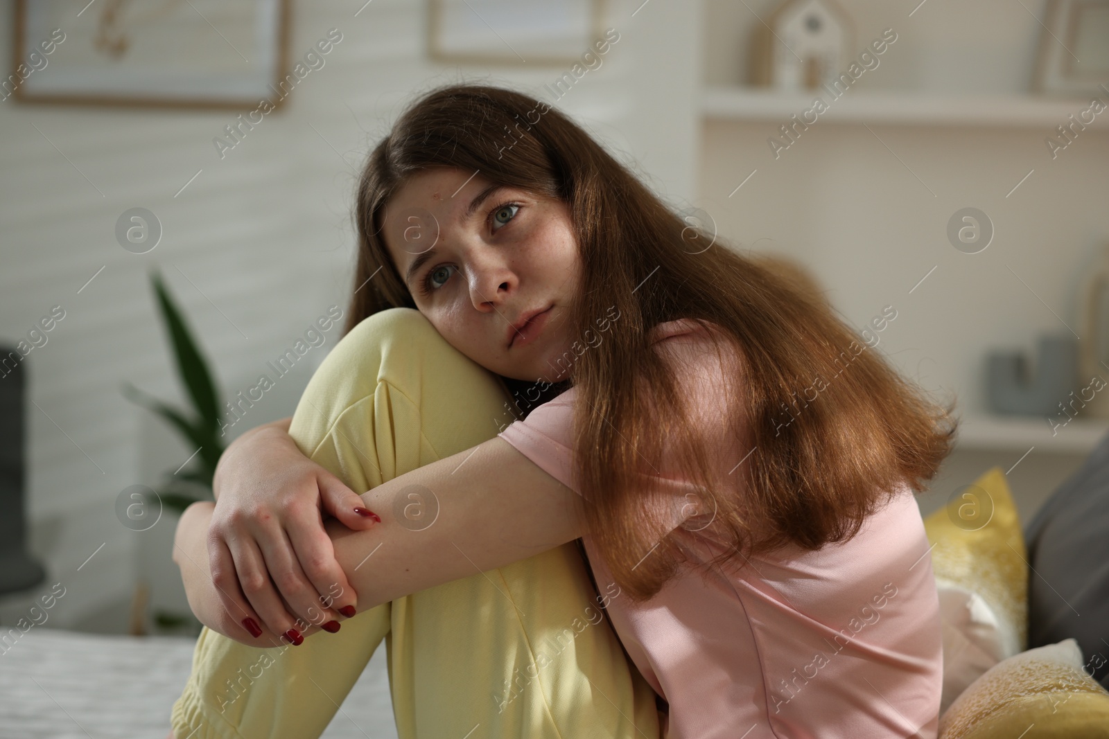 Depressed teenage girl on bed at home Photo of Depressed teenage girl on bed at home
