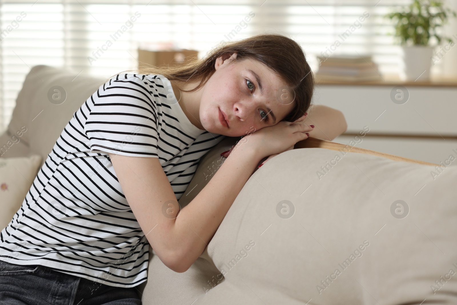 Depressed teenage girl on sofa at home Photo of Depressed teenage girl on sofa at home