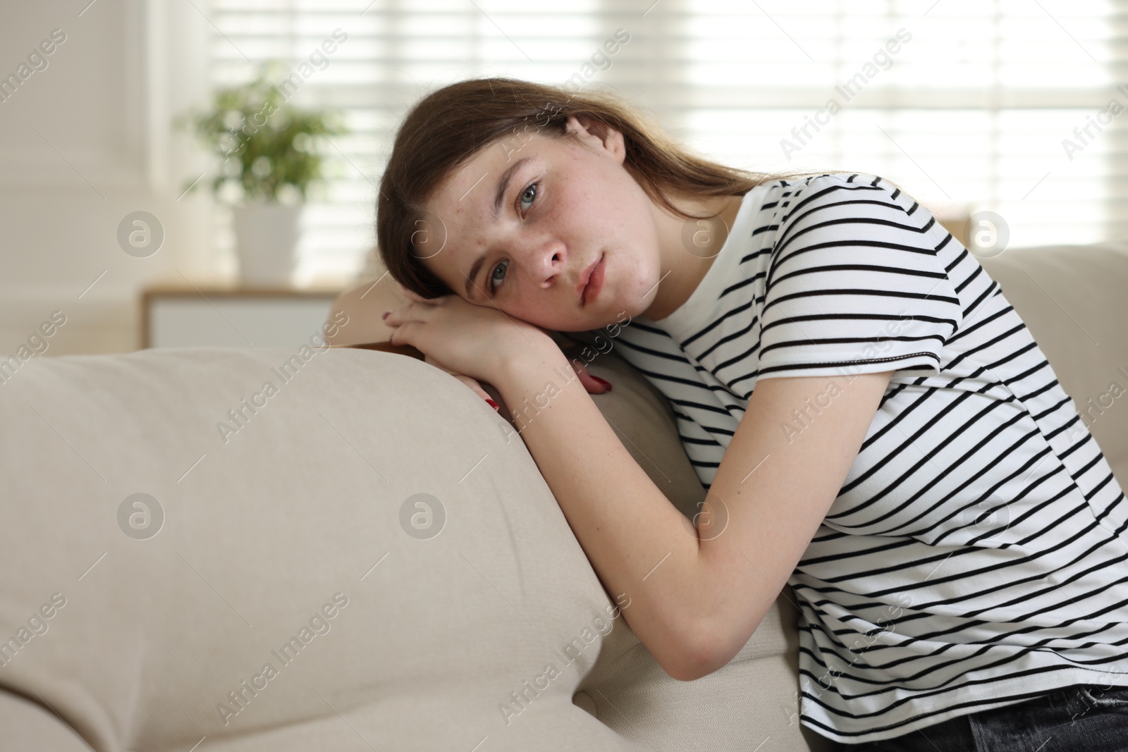 Depressed teenage girl on sofa at home Photo of Depressed teenage girl on sofa at home
