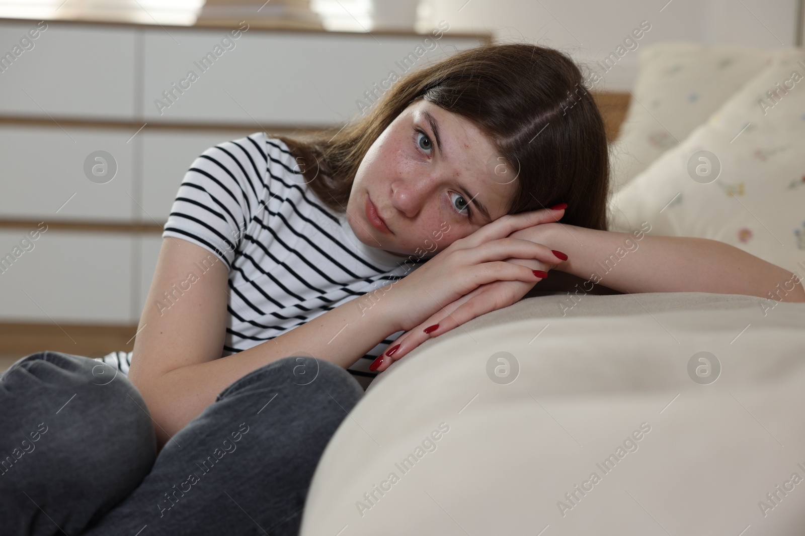 Upset teenage girl on floor at home Photo of Upset teenage girl on floor at home