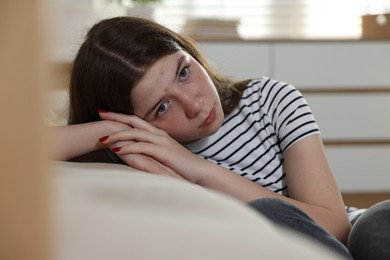 Photo of Upset teenage girl on floor at home