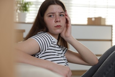 Photo of Upset teenage girl on floor at home