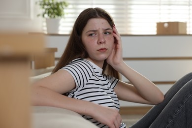 Photo of Upset teenage girl on floor at home