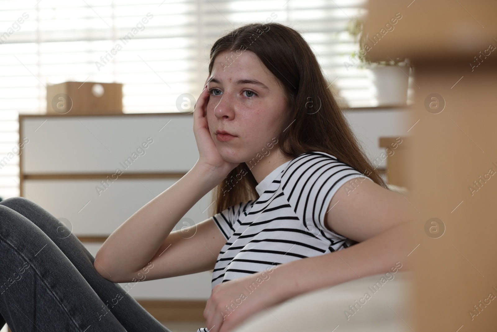 Upset teenage girl on floor at home Photo of Upset teenage girl on floor at home