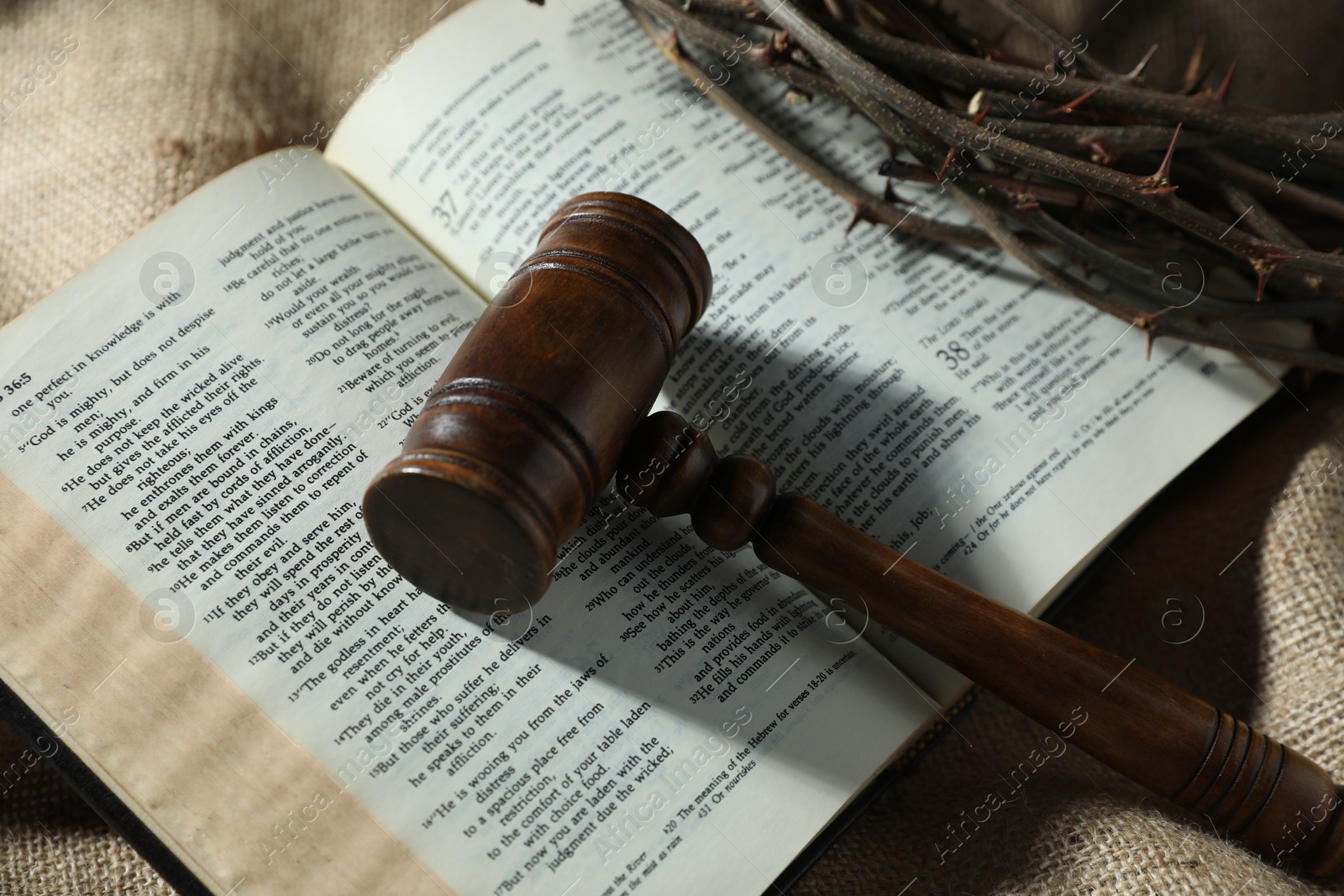 Judge's gavel, Bible and crown of thorns on burlap fabric, above view Photo of Judge's gavel, Bible and crown of thorns on burlap fabric, above view