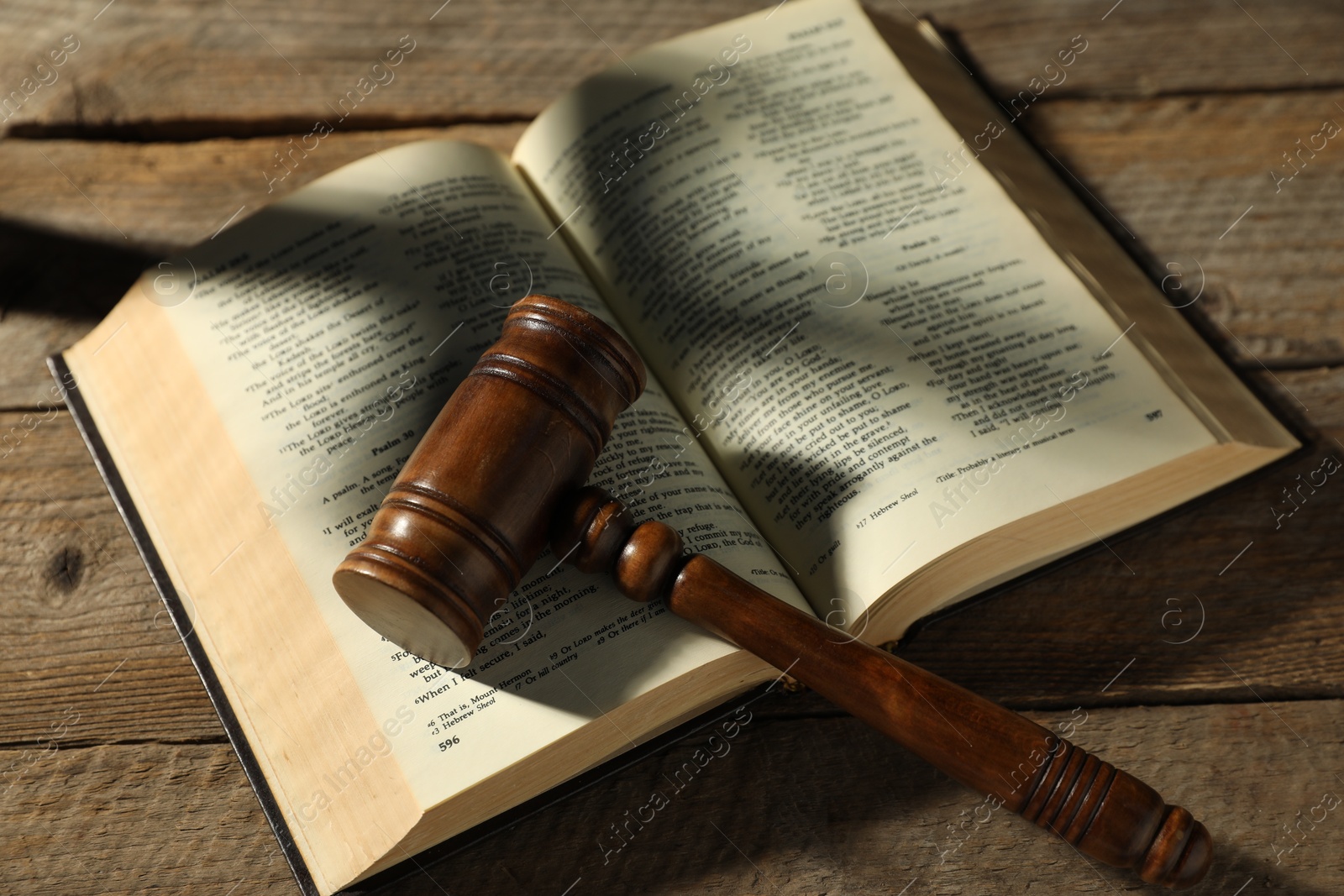 Judge's gavel and Bible on wooden table, above view Photo of Judge's gavel and Bible on wooden table, above view