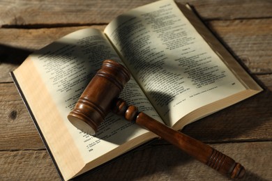 Photo of Judge's gavel and Bible on wooden table, above view