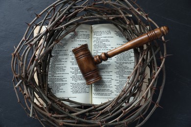 Photo of Judge's gavel, crown of thorns and Bible on black table, top view
