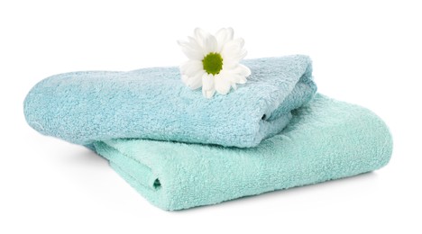 Photo of Soft towels and chrysanthemum flower isolated on white