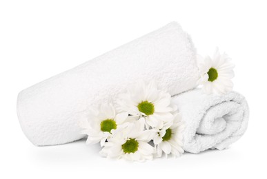 Photo of Soft towels and chrysanthemum flowers isolated on white