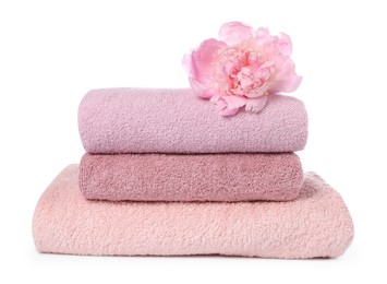 Photo of Stack of towels and peony flower isolated on white
