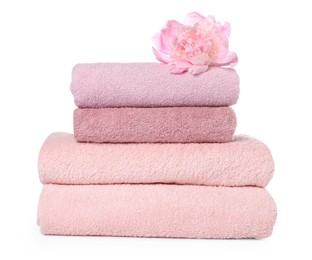 Photo of Stack of towels and peony flower isolated on white