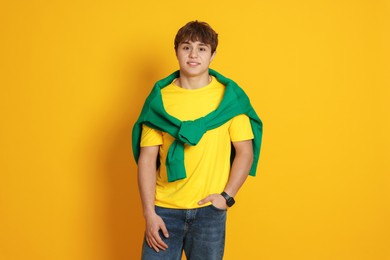 Photo of Portrait of teenage boy on yellow background
