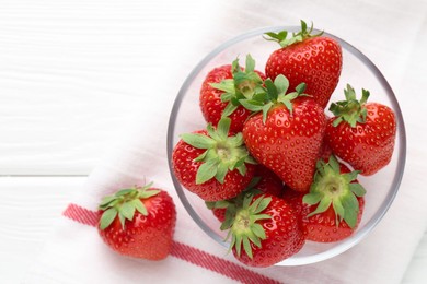 Photo of Fresh ripe strawberries in bowl on white wooden table, top view