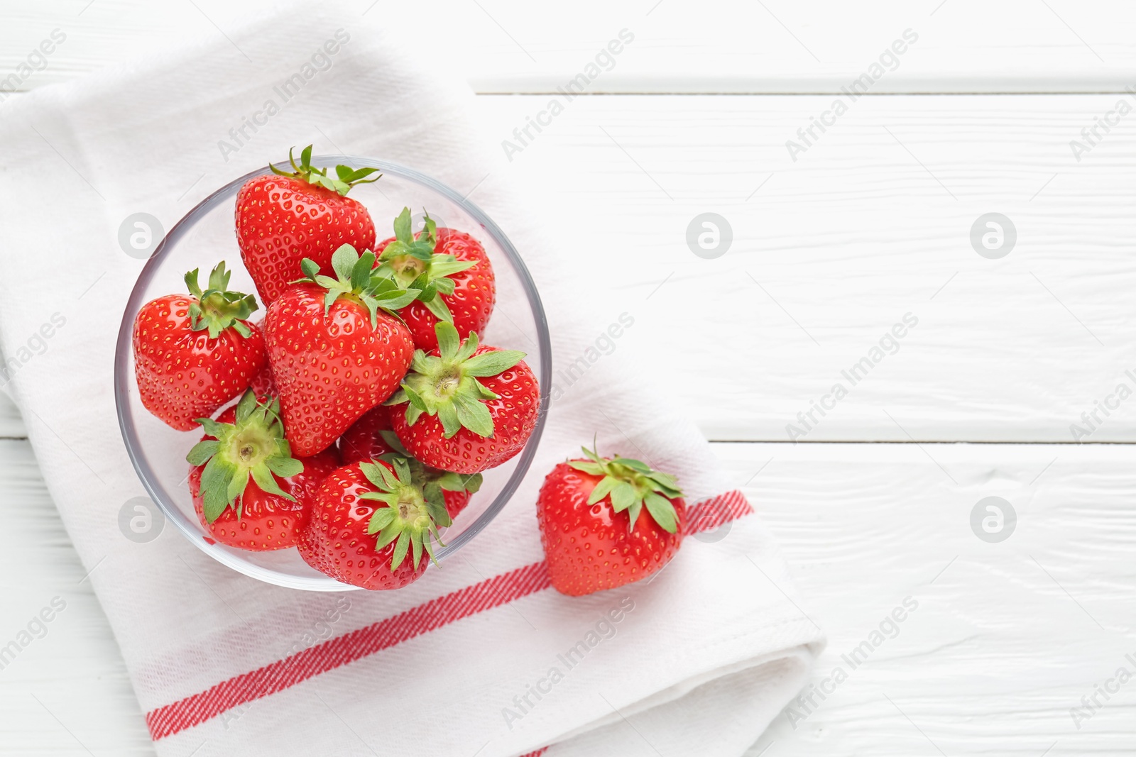 Fresh ripe strawberries in bowl on white wooden table, top view. Space for text Photo of Fresh ripe strawberries in bowl on white wooden table, top view. Space for text
