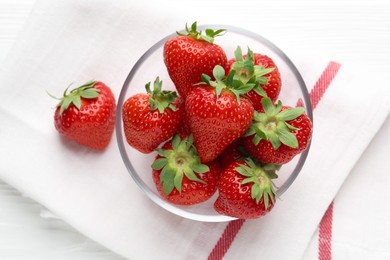 Photo of Fresh ripe strawberries in bowl on white wooden table, top view