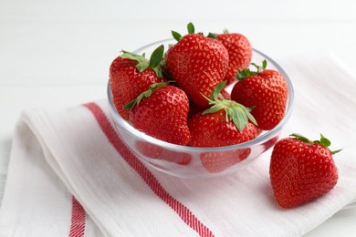 Photo of Fresh ripe strawberries in bowl on white wooden table, closeup