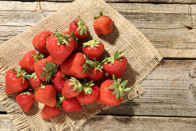 Photo of Fresh ripe strawberries on wooden table, top view