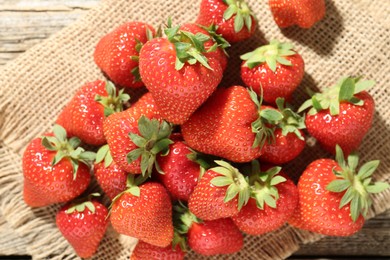 Photo of Fresh ripe strawberries on wooden table, top view