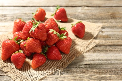 Photo of Fresh ripe strawberries on wooden table, closeup