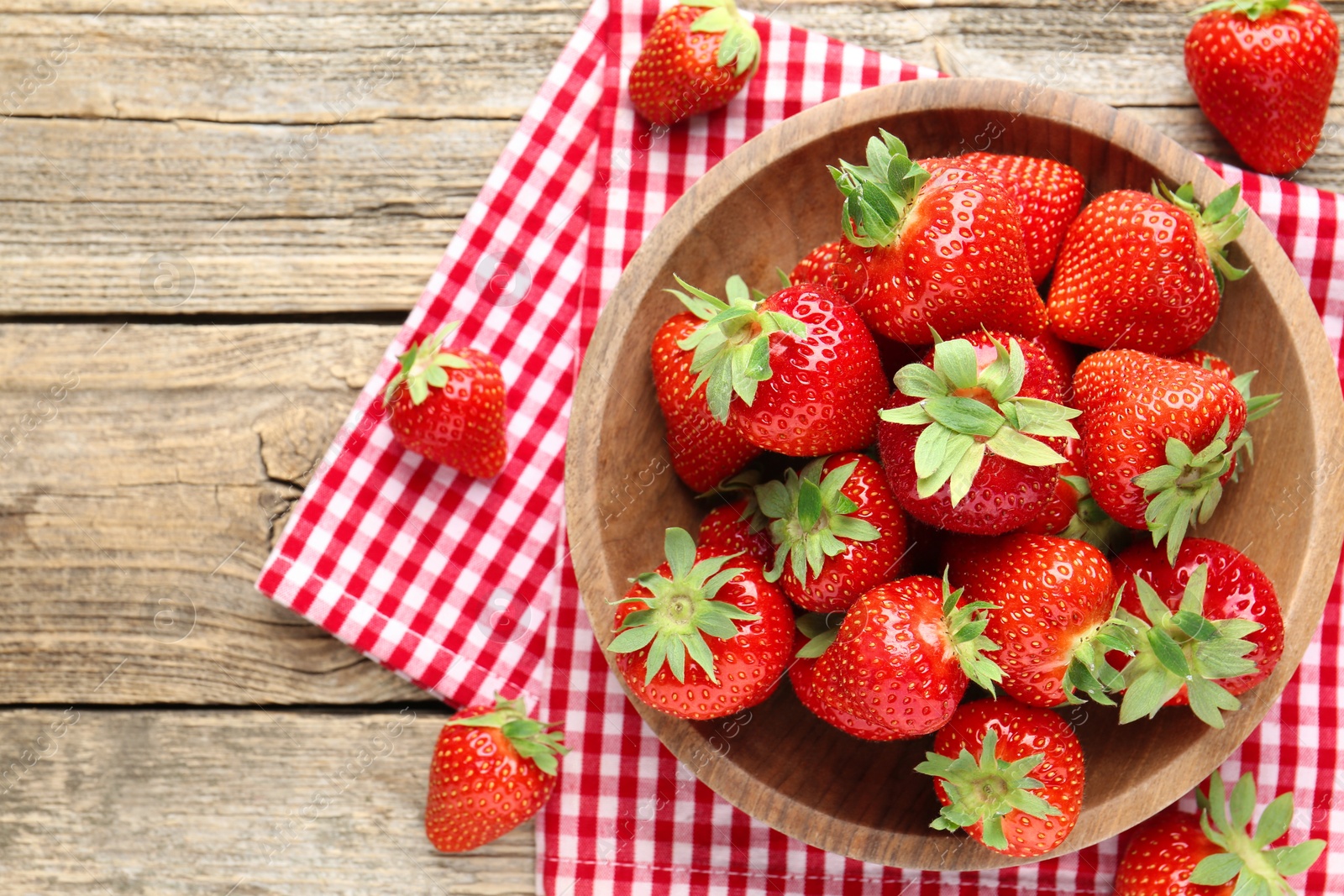 Fresh ripe strawberries in bowl on wooden table, flat lay. Space for text Photo of Fresh ripe strawberries in bowl on wooden table, flat lay. Space for text