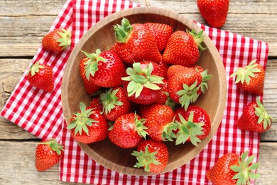 Photo of Fresh ripe strawberries in bowl on wooden table, flat lay