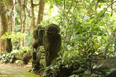 Photo of Bali, Indonesia - June 2, 2025: Ancient sculptures and lush greenery in Ubud Monkey Forest