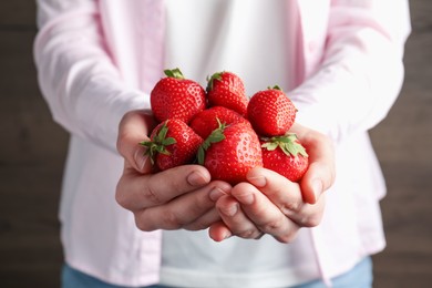 Photo of Woman with delicious ripe strawberries indoors, closeup